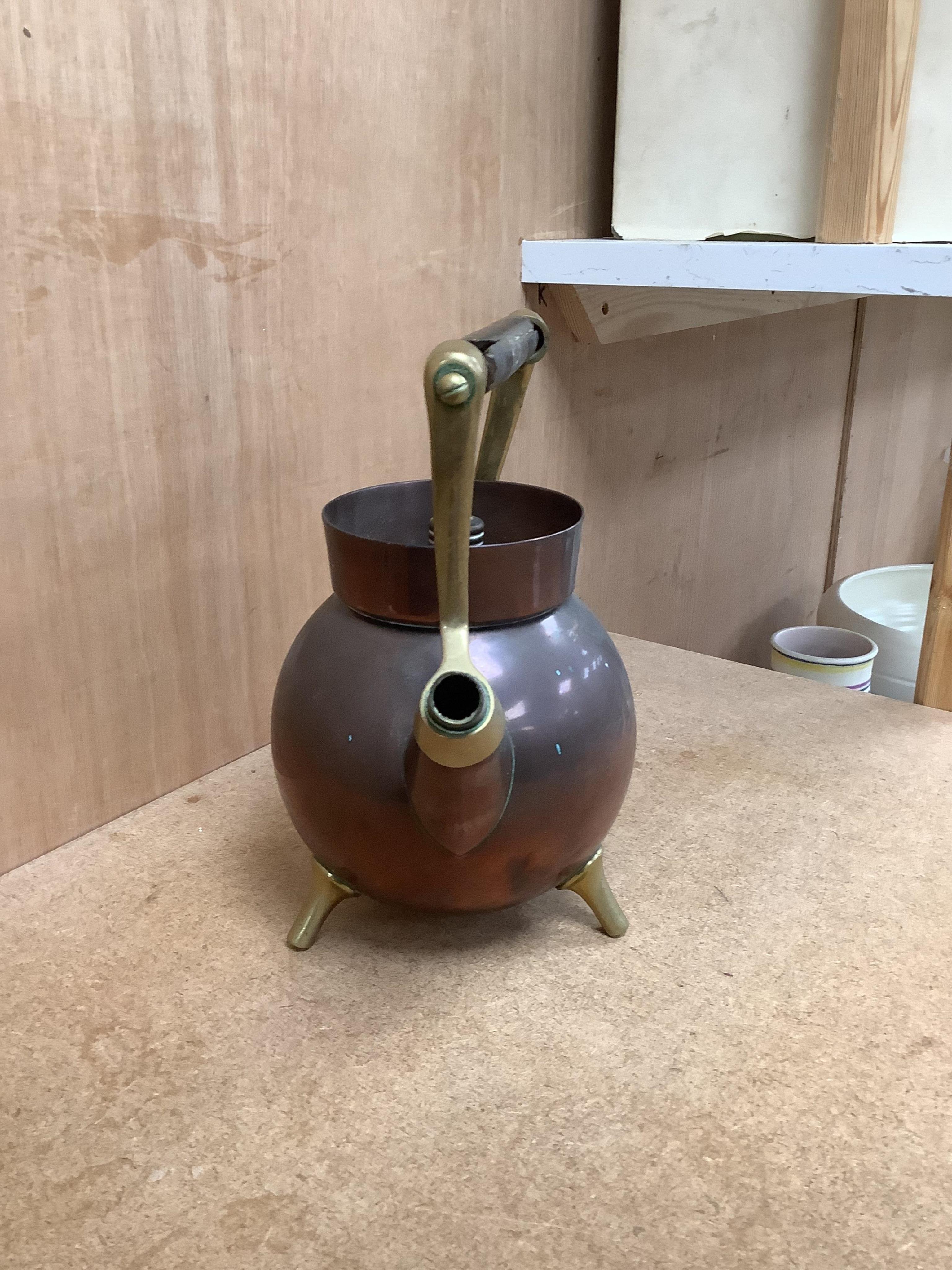 An Arts and crafts copper and brass Benham & Froud stamped Christopher Dresser teapot, (A.F), together with a two handle tray stamped Torini &Sons, Tray 49cm wide.